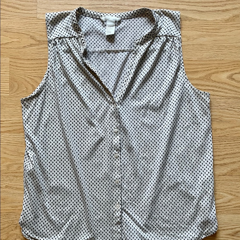 Sleeveless cream blouse with mini black floral pattern